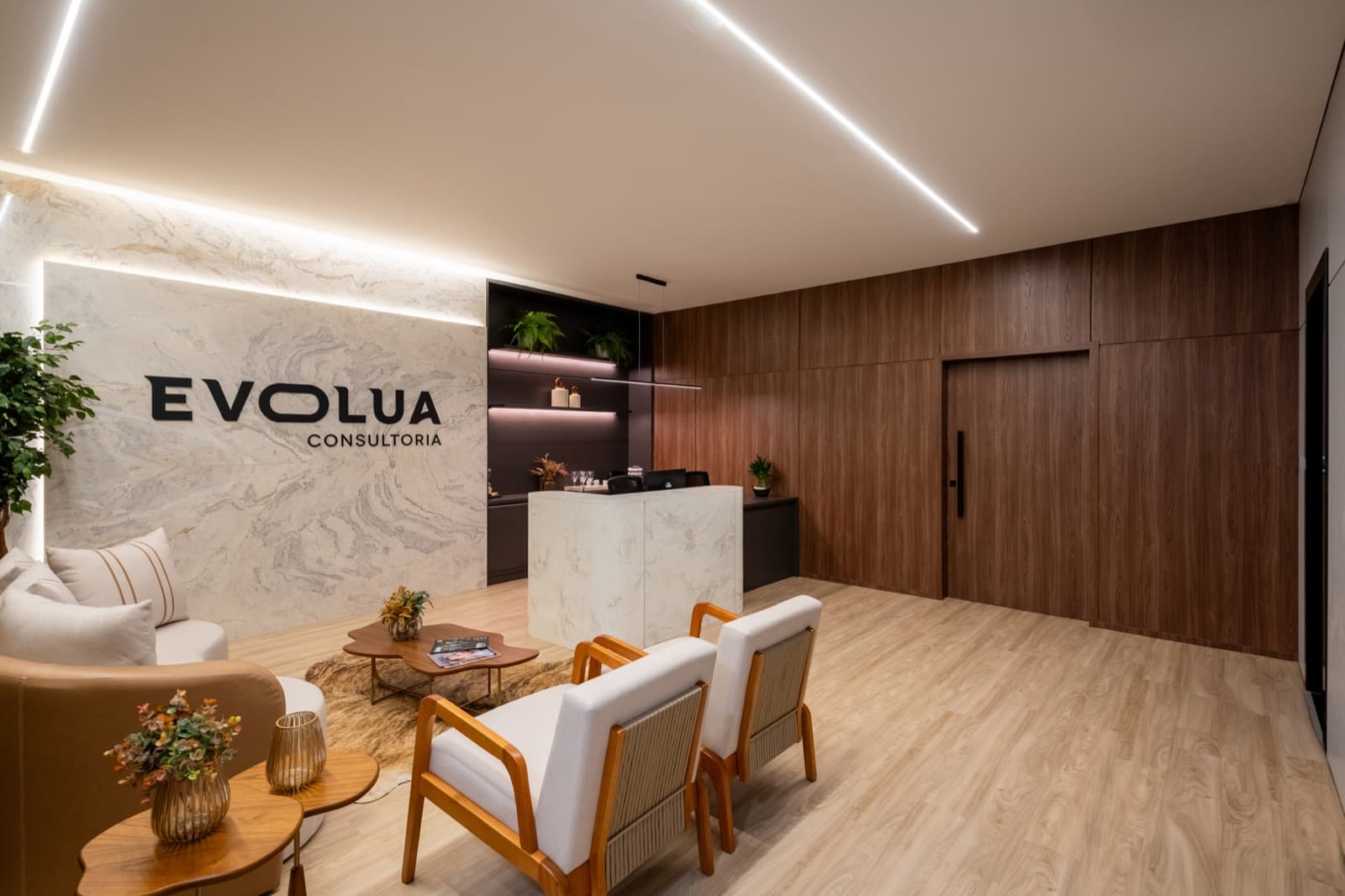 Evolua reception with a marble wall and backlit logo